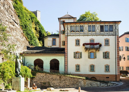 Sion, Switzerland - August, 25, 2016: Building architecture at the old town of Sion, Canton Valais, Switzerland. Woman with dog on the backgroundのeditorial素材