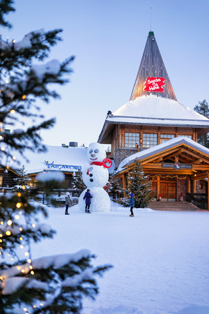 Rovaniemi, Finland - March 5, 2017: Snowman at Santa Office at Santa Claus Village in Lapland, Finland, on Arctic Circle in winter. People on the backgroundのeditorial素材