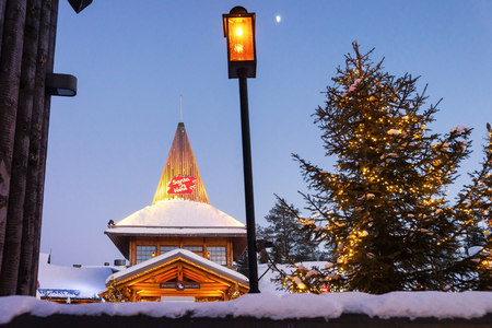 Rovaniemi, Finland - March 5, 2017: Santa Claus Office in Santa Village with Christmas trees in the evening, Lapland, Finland, on Arctic Circle in winter.のeditorial素材