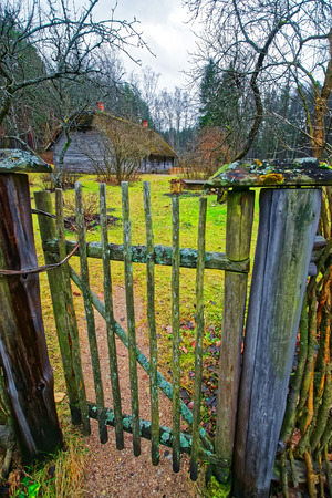Old house and wooden fence in Ethnographic open air village, Riga, Latviaのeditorial素材