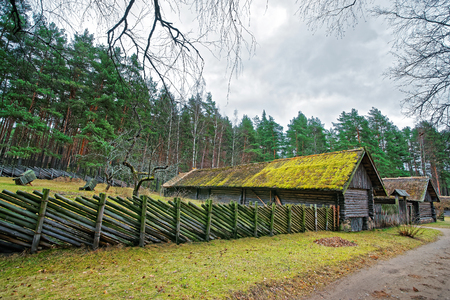 Old building and wooden fence in Ethnographic open air village in Riga, Latviaのeditorial素材