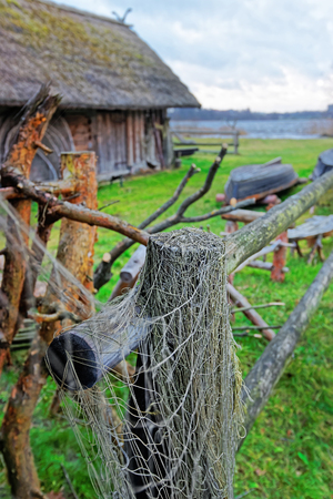 Fishing net hanging on the fence at Ethnographic open air village in Riga, Latviaのeditorial素材