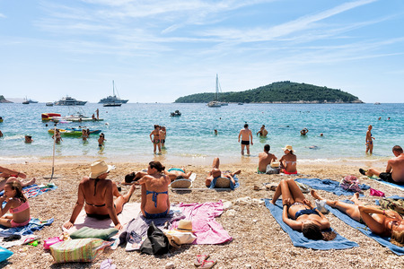 Dubrovnik, Croatia - August 20, 2016: People sunbathing on beach at Adriatic Sea in Dubrovnik, Croatiaのeditorial素材