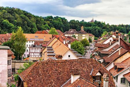 Street with old houses roof tops in Bern, Switzerland. Seen from Nydeggbrucke bridge