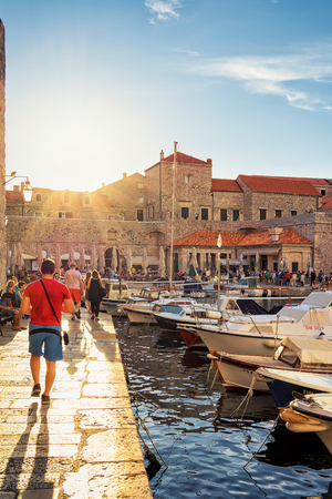Dubrovnik, Croatia - August 18, 2016: People at Old port in Dubrovnik, Croatia, at sunsetのeditorial素材