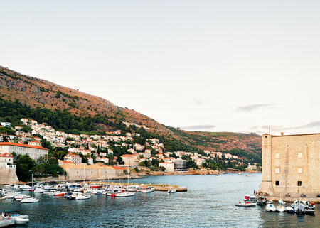 Evening at Saint John Fortress and Sailing boats and people at the Old port in the Adriatic Sea in Dubrovnik, in Croatiaの写真素材
