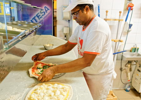 Florence, Italy - October 15, 2016:  Chef preparing Margherita pizza at pizzeria restaurant, Florence, Tuscany, Italy.のeditorial素材