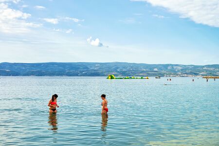 Omis, Croatia - August 18, 2016: People in Adriatic Sea in Omis, Dalmatia, Croatiaのeditorial素材