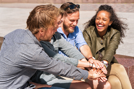 Group of smiling friends holding hands. Togetherness conceptの写真素材