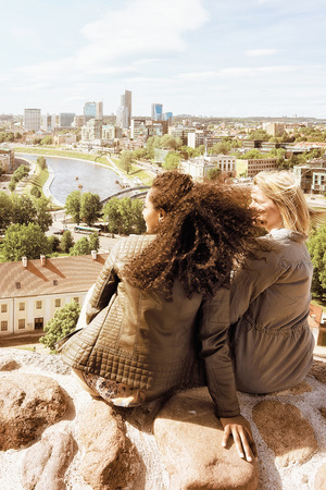 Two girl friends enjoying the city skyline view conceptの写真素材