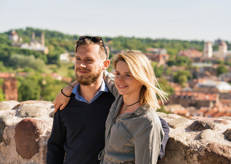 Smiling young brother and sister embracing each other as a friendship and togetherness conceptの写真素材