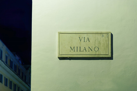 Via Milano street sign on the wall in Rome, Italyの写真素材