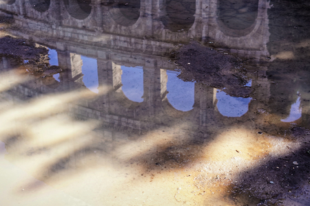 Colosseum reflection in puddle of water after rain, Rome, Italyの写真素材