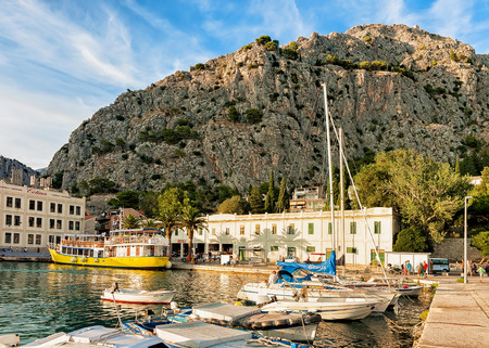Omis, Croatia - August 17, 2016: SailBoats at the harbor of the Adriatic Sea in Omis, Dalmatia, Croatia. People on the backgroundのeditorial素材