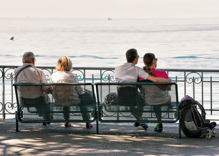 Montreux, Switzerland - August 27, 2016: People sitting on the bench on the embankment of Geneva Lake in Montreux, Swiss Rivieraのeditorial素材