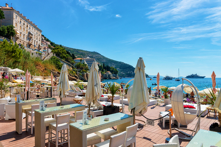 Dubrovnik, Croatia - August 20, 2016: Shelter and deckchairs at beach at Adriatic Sea, Dubrovnik, Croatiaのeditorial素材