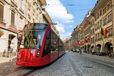 Bern, Switzerland - August 31, 2016: Running tram and people at Marktgasse street in old city center...