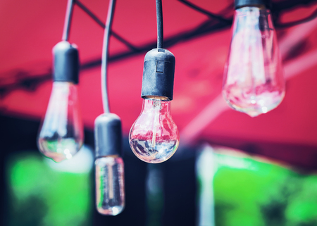 Light bulbs hanging in the street cafe