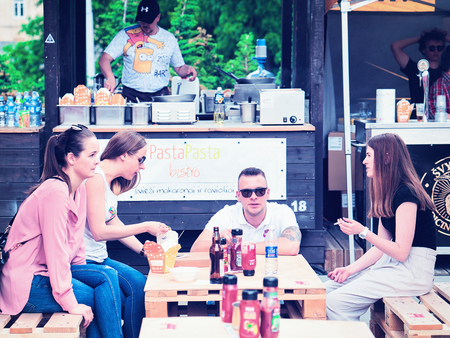Vilnius, Lithuania - June 9, 2017: Young people eating fast food at Open Kitchen food festival in Vilnius, Lithuania.のeditorial素材