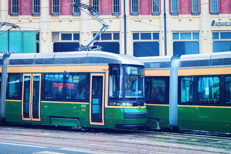 Helsinki, Finland - March 8, 2017: Green trams in the Street of Helsinki, Finland in winter.のeditorial素材