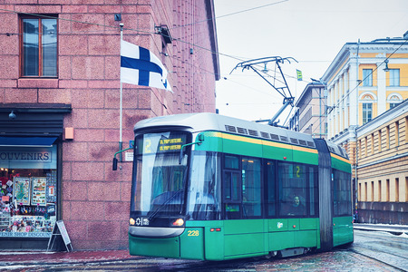 Helsinki, Finland - March 8, 2017: Green tram in the Street in Helsinki, Finland in winter.のeditorial素材