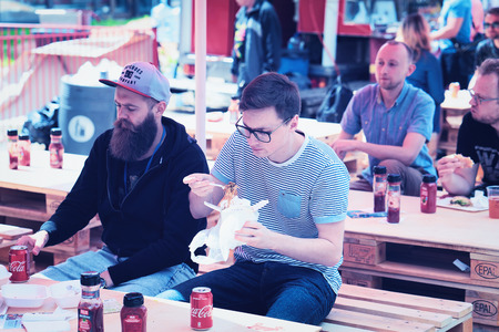 Vilnius, Lithuania - June 9, 2017: Friends eating fast food at Open Kitchen food festival in Vilnius, Lithuania.のeditorial素材