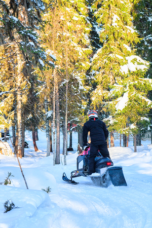 Rovaniemi, Finland - March 5, 2017: Person riding a snowmobile on the frozen lake, at winter Rovaniemi, Lapland in Finlandのeditorial素材