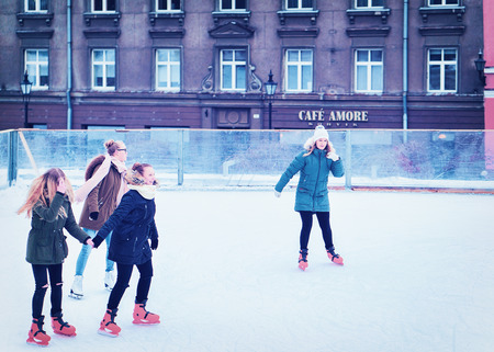Tallinn, Estonia - February 27, 2017: Group of female teenagers ice skating on the rink at the Old town of Tallinn, Estonia in winterのeditorial素材
