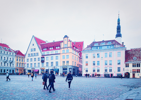 Tallinn, Estonia - February 27, 2017: People at Town Hall Square in the Old city of Tallinn, Estonia in winter. Church of Holy Spirit on the backgroundのeditorial素材