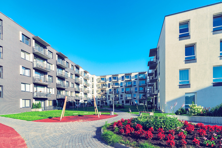 Vilnius, Lithuania - August 1, 2017: Complex of new apartment residential building with children playground and flowerpot as outdoor facilities.のeditorial素材
