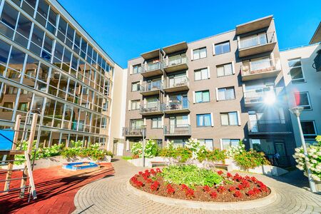 Vilnius, Lithuania - August 1, 2017: Complex of new apartment residential buildings with children playground and flowerpot as outdoor facilities.のeditorial素材