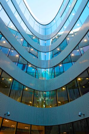 Vilnius, Lithuania - August 8, 2017: Fragment of modern futuristic steel and glass skyscraper architecture reflecting the blue skyのeditorial素材