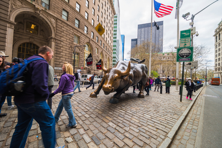 New York, USA - April 24, 2015: Charging Bull at Wall Street in Financial District in Lower Manhattan, New York, NYC, USA. Tourists in the streetのeditorial素材
