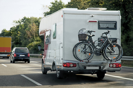 Caravan with bicycles and cars in the road at Switzerland.の写真素材