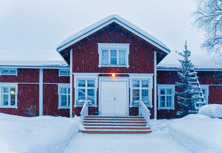 Snow covered Cottage in winter Rovaniemi, Lapland, Finland, at snowfall.のeditorial素材