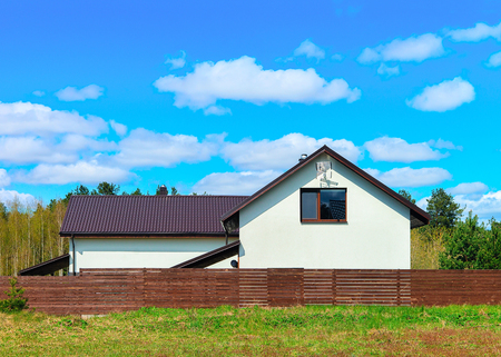 Modern cottage house with fence and small courtyardのeditorial素材