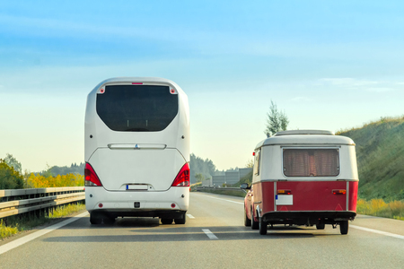 Camper and bus on the road in Switzerland.の写真素材