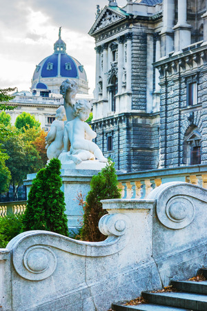 Vienna, Austria - August 31, 2012: Sculpture of putti angels at staircase in Burggarten, Vienna in Austria. Neue Burg is part of Hofburg and Historical Museum on the backgroundのeditorial素材