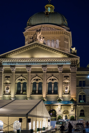 Bern, Switzerland - August 21, 2013: Facade of Federal Palace of Switzerland in Bern, Switzerland. Illuminated late in the evening. People on the backgroundのeditorial素材