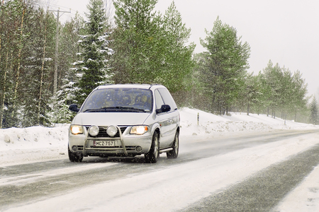 Rovaniemi, Finland - March 1, 2017: Car with head lamp in the snowy road in Rovaniemi in winter Lapland, Finlandのeditorial素材