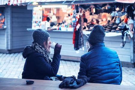 Riga, Latvia - December 28, 2016: Tourists drinking hot wine on Christmas Market at Dome Square in Riga Old Town in winterのeditorial素材