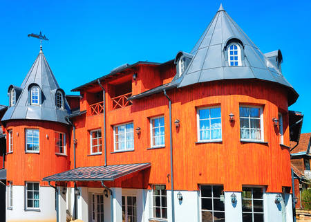 Druskininkai, Lithuania - May 1, 2017: Modern red wooden red country house with towers in Druskininkai, Lithuaniaのeditorial素材
