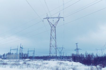Electric transmission line at the snowy road at winter Rovaniemi, Lapland, Finlandの写真素材
