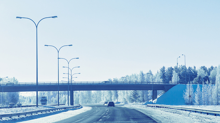 Cars in the road in winter Rovaniemi, in Lapland, Finland. Bridge on the backgroundの写真素材
