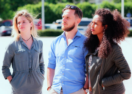 Young multiracial friends with arabic girl and Dutch people when looking serious as part of diversity friendship and togetherness conceptの写真素材