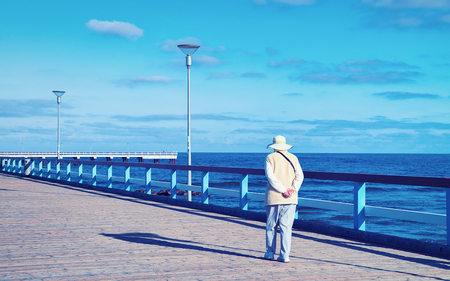Woman on the Sea Bridge over the Baltic sea in Palanga resort, Lithuaniaの写真素材