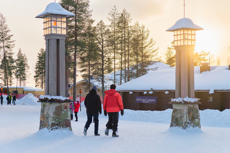 Rovaniemi, Finland - March 5, 2017: Tourists at Arctic Circle Lanterns in Santa Village with Christmas trees in Lapland, Finland, Scandinavia, on Arctic Circle in winter.のeditorial素材