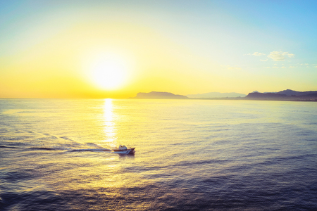 Sunrise and ship at the Mediterranian sea at Palermo, Sicily, Italyの写真素材