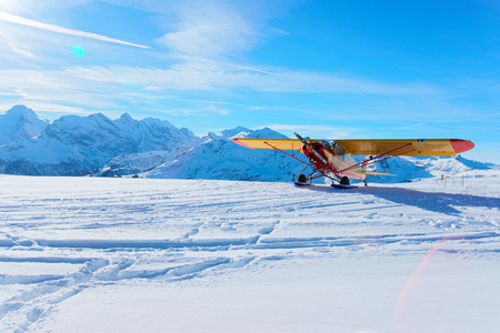 Mannlichen, Switzerland - December 31, 2013: Yellow airplane at Mountain peaks in Mannlichen in winter Swiss Alpsのeditorial素材