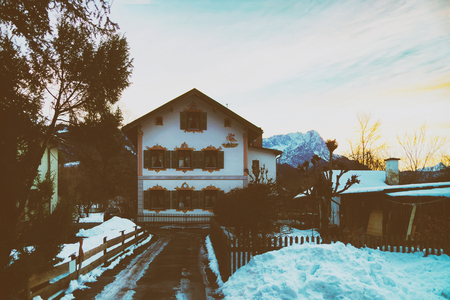 Garmisch-Partenkirchen, Germany - January 6, 2015: Residential building in Garmisch-Partenkirchen with bright green shutters and beautiful facade painting. Tonedのeditorial素材